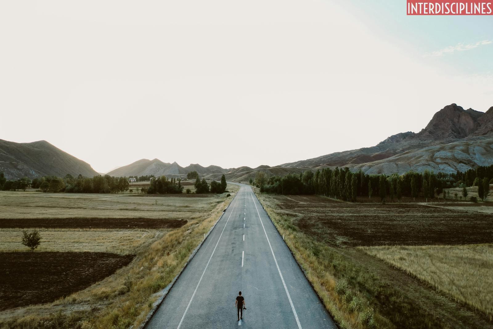 A Person Standing Alone on Country Road
