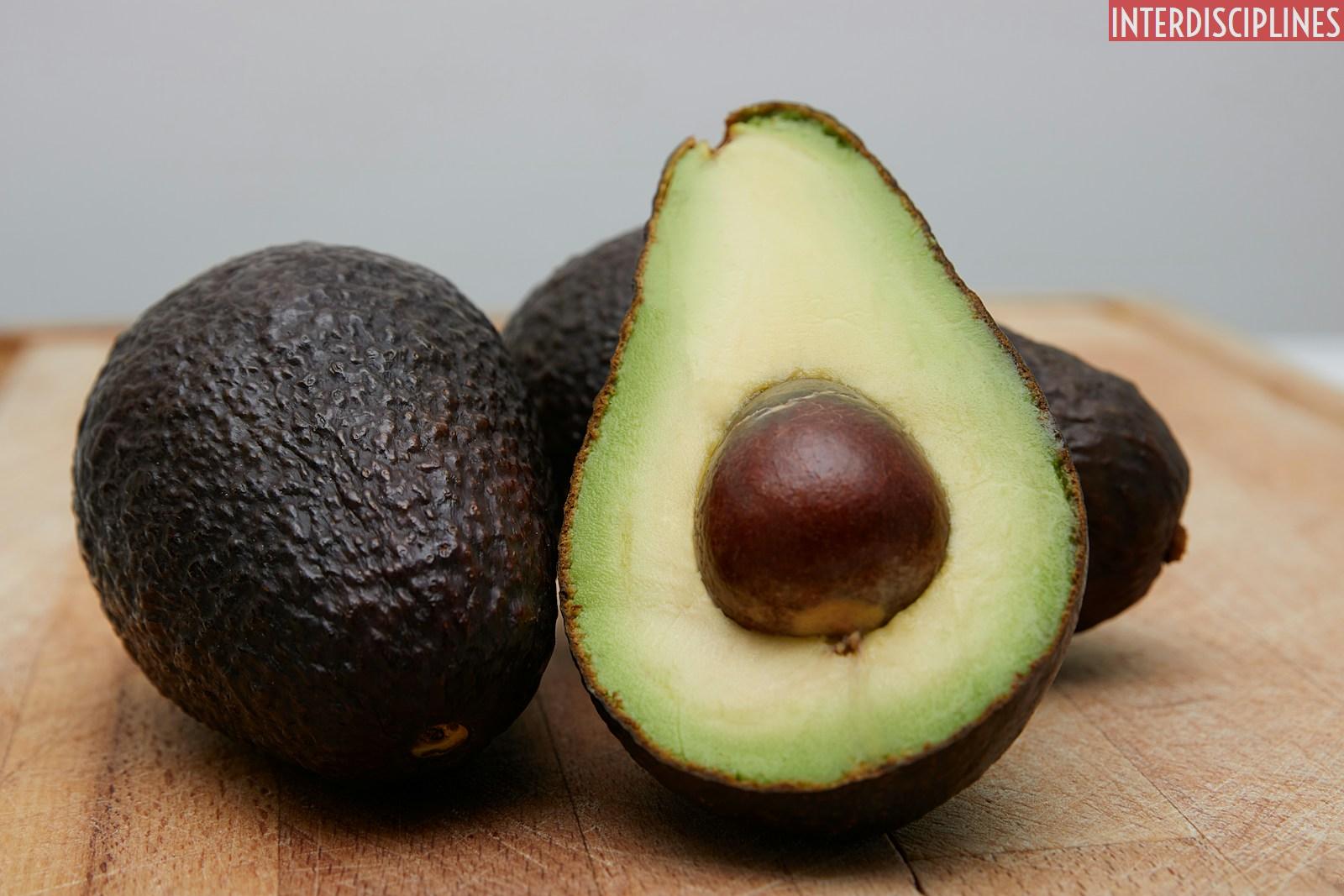 sliced avocado fruit on brown wooden table