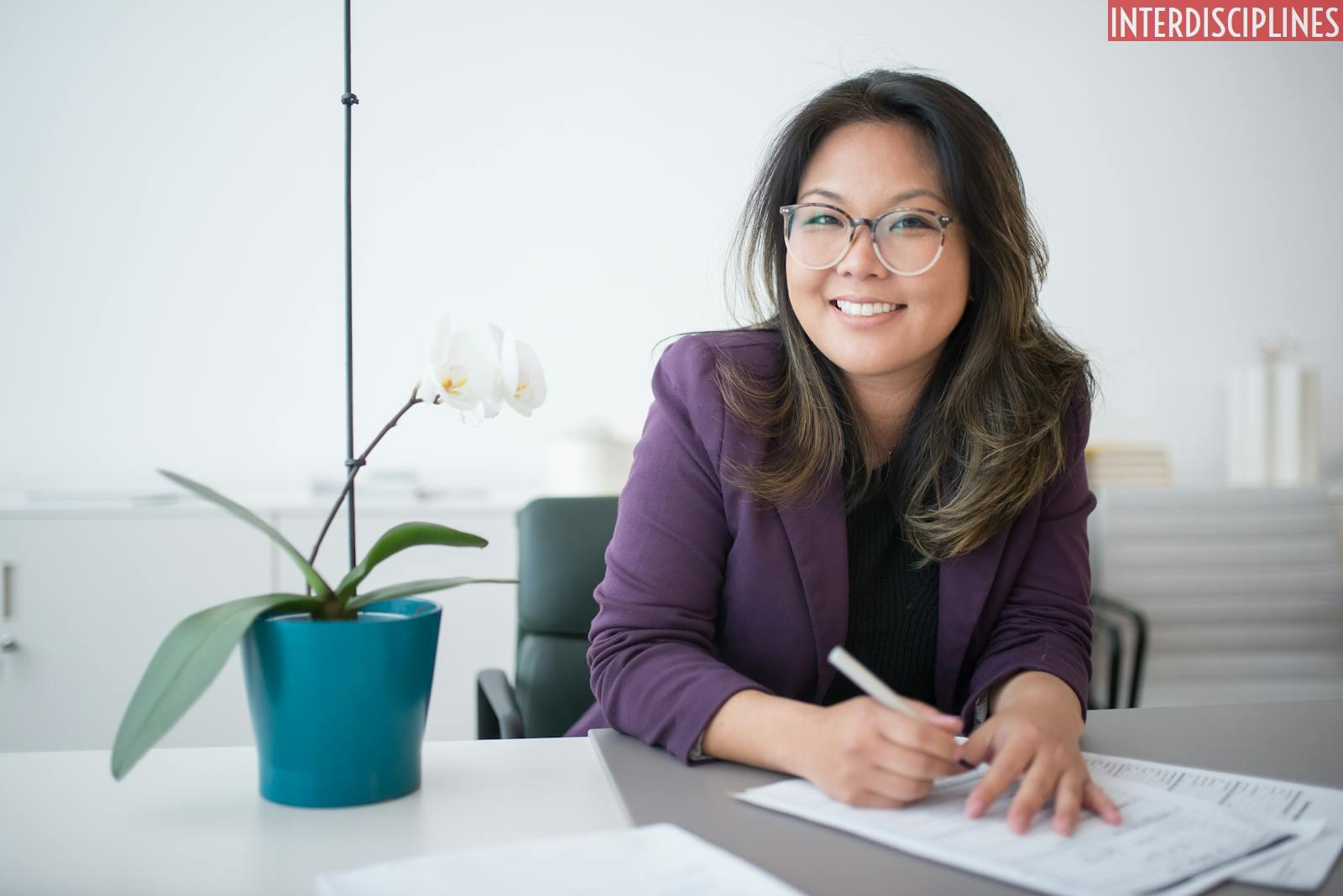 A Woman Sitting on a Table with Potted Plant