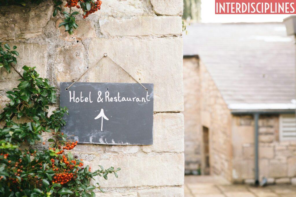 Hotel & Restaurant signage posted on concrete wall
